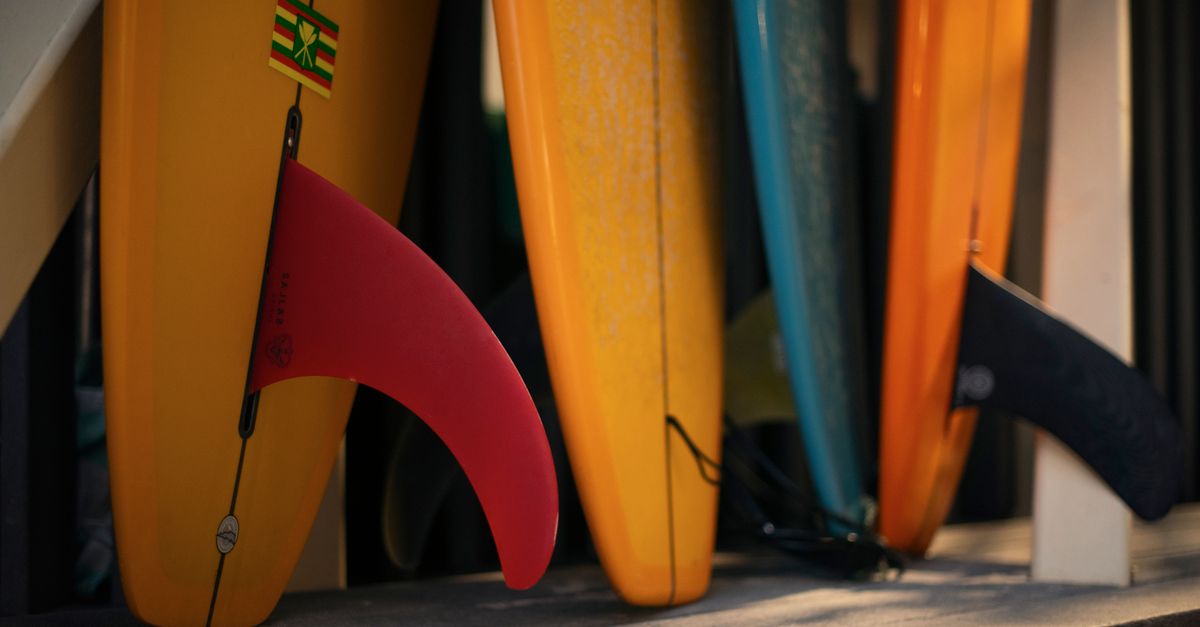 A close-up of vibrant surfboards with fins ready for summer fun in Honolulu, HI.